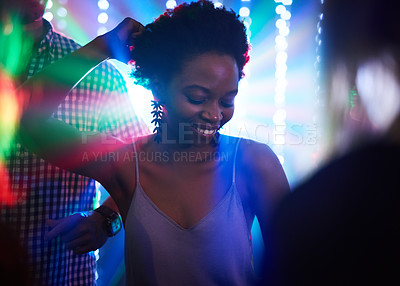 Buy stock photo Shot of a young woman dancing in a nightclub