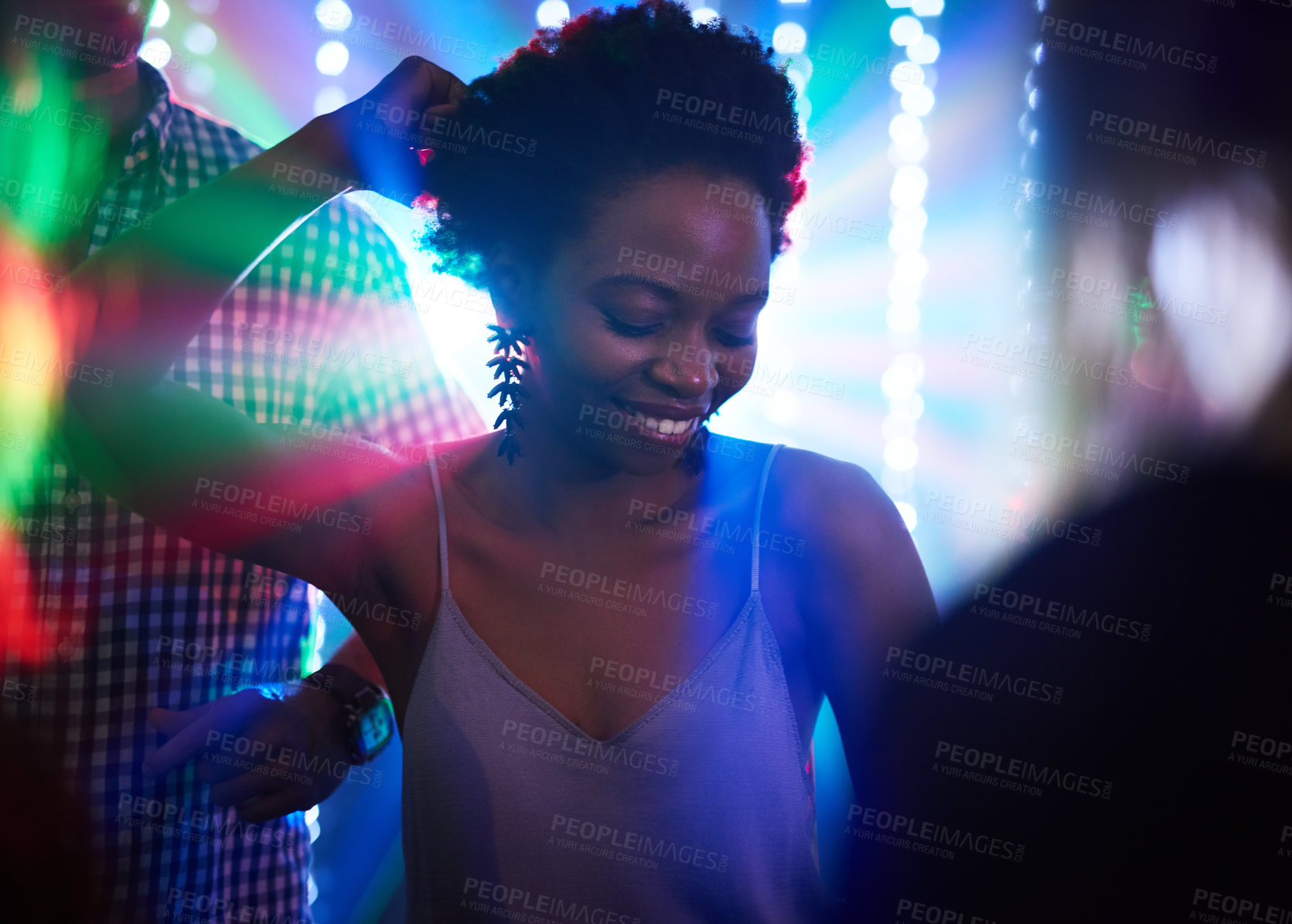 Buy stock photo Shot of a young woman dancing in a nightclub