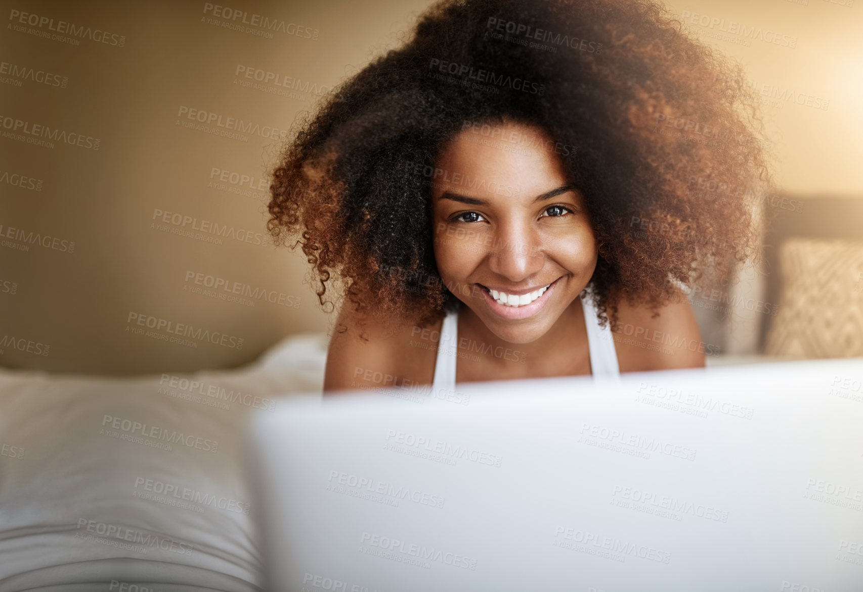 Buy stock photo Portrait of a relaxed young woman using a laptop on her bed in the morning