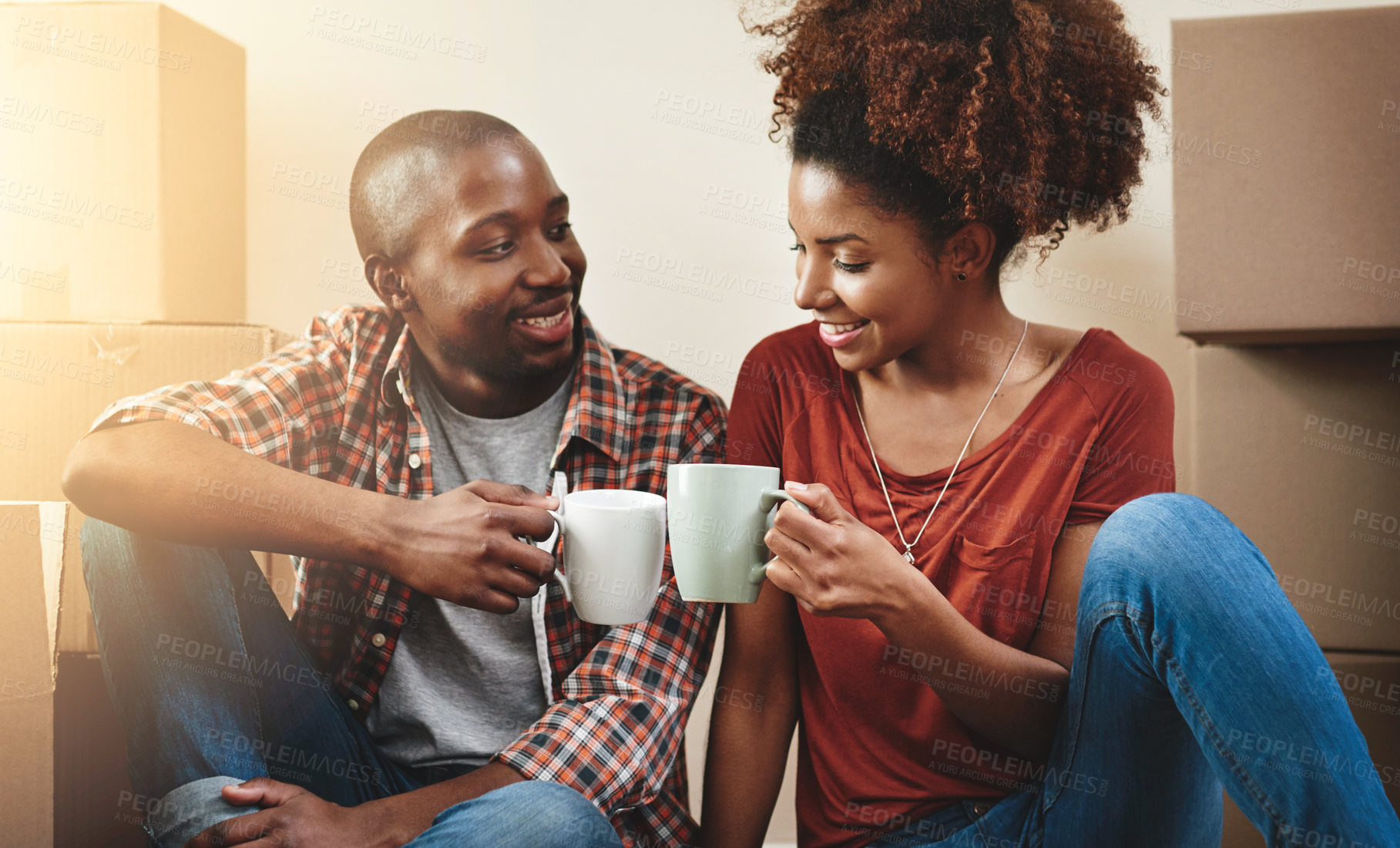 Buy stock photo Black couple, cheers and coffee on floor of new house with bonding, support and happy for break from moving. People, homeowner and toast for property investment, dream home and relocation with boxes
