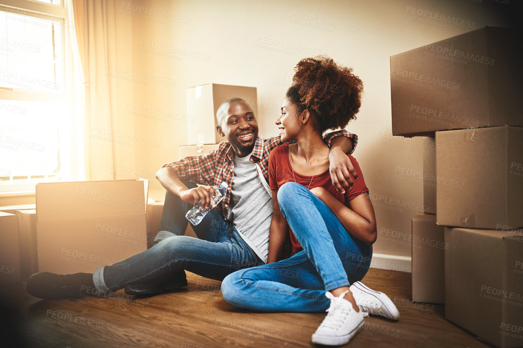 Buy stock photo Black couple, real estate and embrace on floor of new house with bonding, support and break from moving day. People, homeowner and excited for property investment, dream home or relocation with boxes