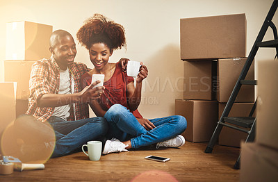 Buy stock photo Couple, online and moving with phone in home to research property, app and reading mortgage info. Happy, people and relax on website for interior design ideas, furniture or watch diy renovation video