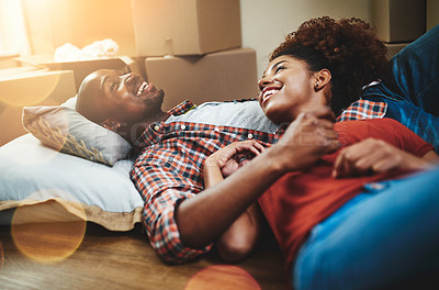 Buy stock photo Black couple, relax and smile on floor of new house with bonding, support and break from moving. People, homeowner and excited for property investment, dream home or real estate relocation with boxes