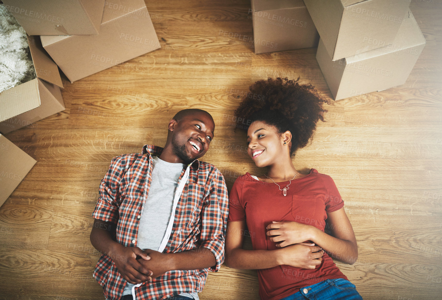 Buy stock photo Relax, moving and happy couple on floor in new house with boxes, talking and mortgage with high angle. Smile, black man and woman in home together with future planning, love and property investment
