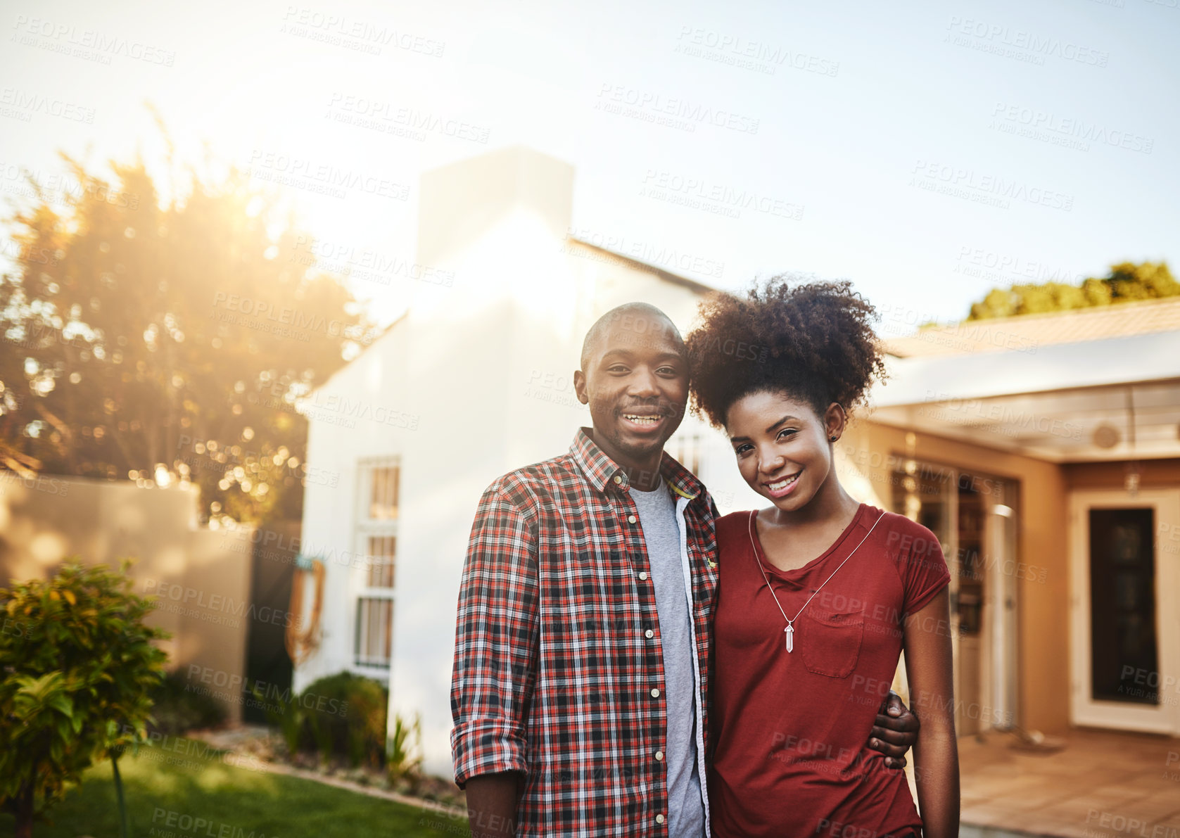 Buy stock photo Portrait of a young couple standing outside in front of their new house