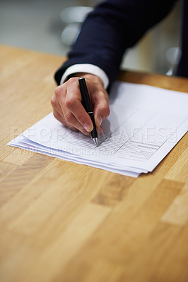 Buy stock photo Closeup shot of a businessman sitting at a table in an office going through a checklist