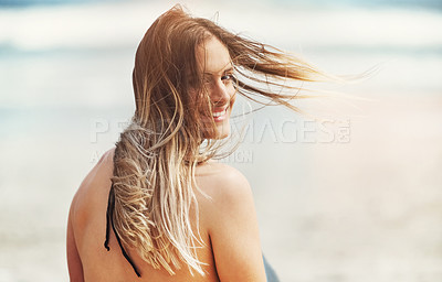 Buy stock photo Portrait of an attractive young woman standing on a beach