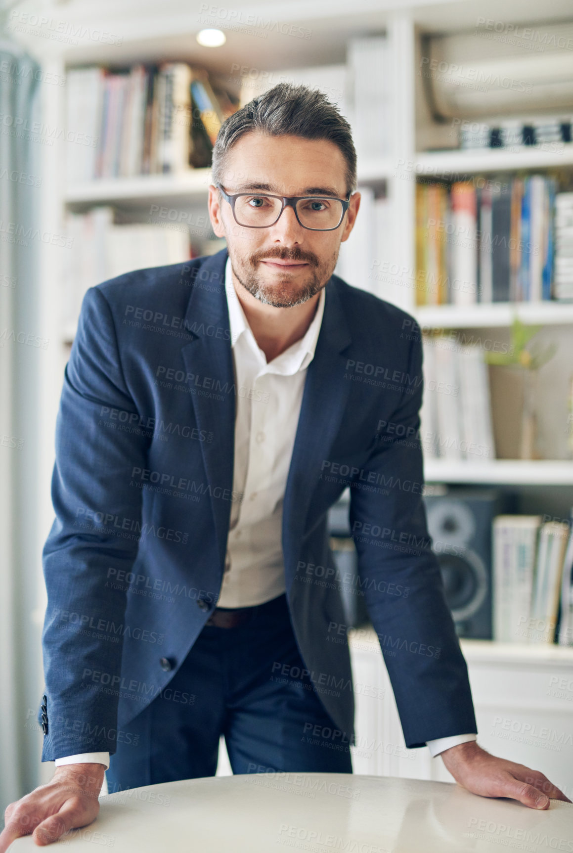 Buy stock photo Portrait, serious and business man on desk in office for career or job in Canada. Glasses, confidence and professional attorney on table, entrepreneur and corporate employee in suit at workplace