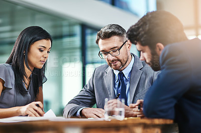 Buy stock photo Shot of a group of colleagues working together in an office