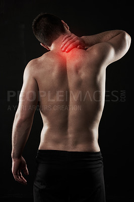 Buy stock photo Studio shot of a sporty young man suffering with neck pain isolated on black