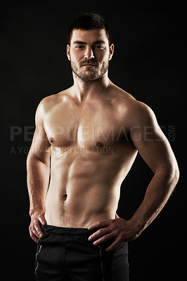 Buy stock photo Studio portrait of a sporty young man isolated on black