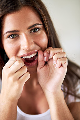 Buy stock photo Portrait of a beautiful woman flossing her teeth with dental floss
