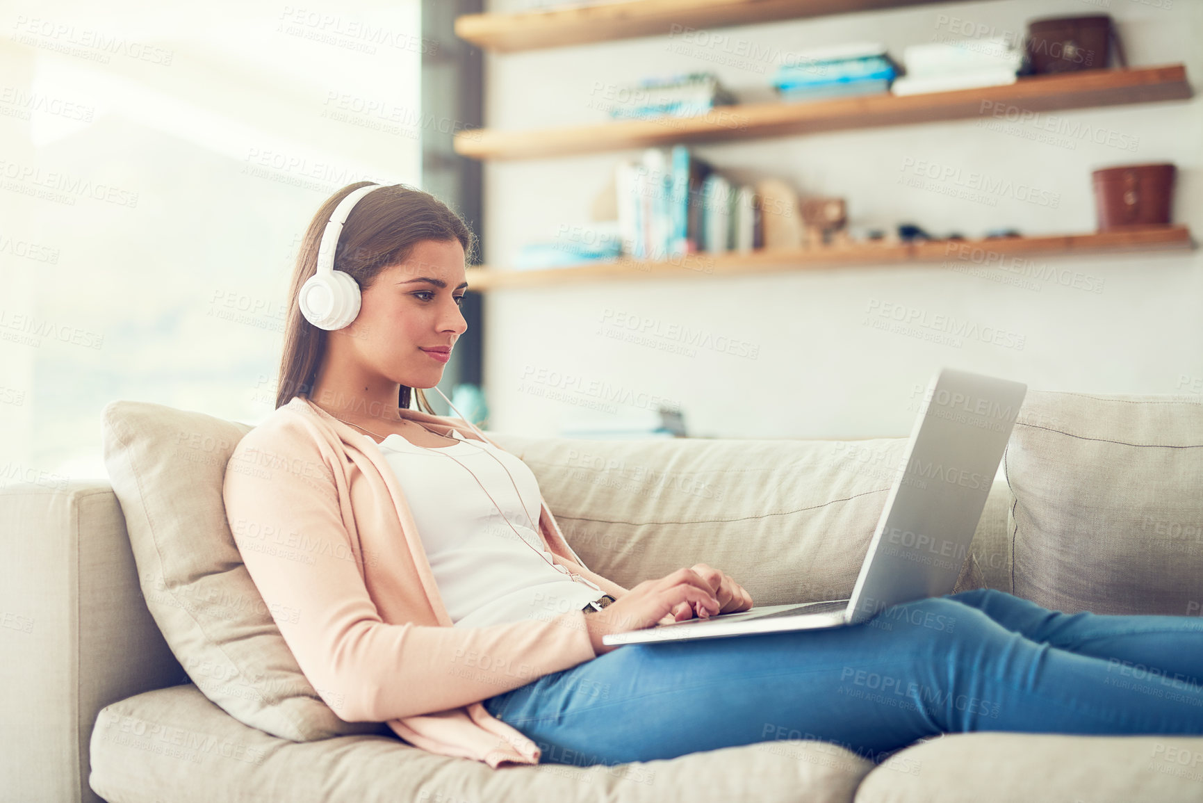 Buy stock photo Woman, laptop and headphones with video on sofa in home for audio streaming, subscription service and social media. Person, music and watching series with movie entertainment, radio playlist or sound