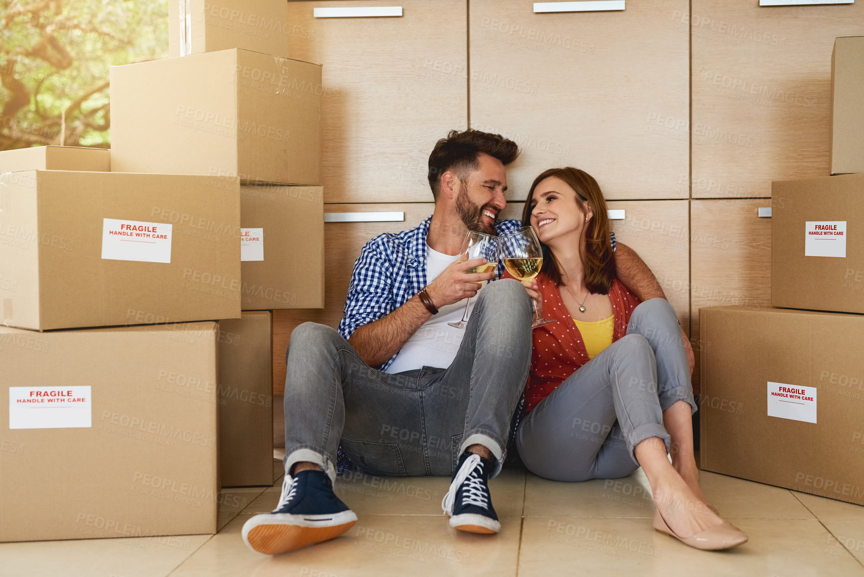 Buy stock photo Couple, boxes and wine in house for cheers, relief and celebration for moving or new home. Happy man, woman and cardboard for packaging in living space with smile, toast and happiness for mortgage