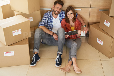 Buy stock photo Portrait of a young couple taking a break while moving into their new home