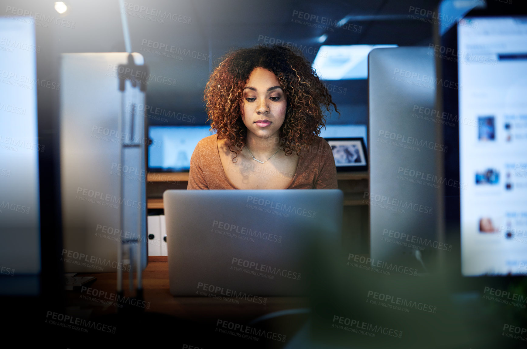 Buy stock photo Shot of a young woman working late in an empty office