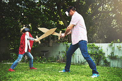 Buy stock photo Father, son and play fighting with sword for bonding or VR in costume, cosplay or backyard at home. Fun dad, child or little boy enjoying outdoor game on grass field, lawn or virtual reality at house