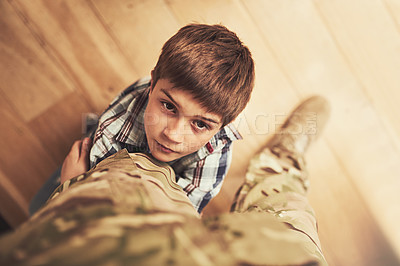 Buy stock photo Shot of a young boy clinging to his father's leg to stop him from going to the army