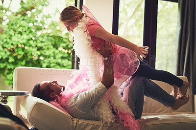 Buy stock photo Home, play or dad with princess or girl on sofa in living room with pink costume, smile or fun parent. Happy family, flying fairy or father and an excited child for dress up, love or games with wings