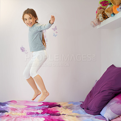 Buy stock photo Portrait of a cute little girl jumping on her bed at home