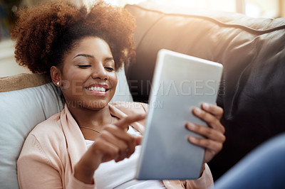 Buy stock photo Woman, typing and home or happy on tablet, relax and internet communication or social media scrolling. Reading, text and blog or online networking, meme and funny on tech on sofa in apartment