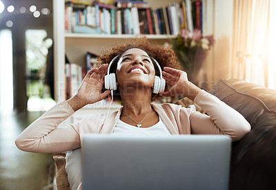 Buy stock photo Relax, laptop and woman on couch with headphones, smile and happy morning streaming in living room. Rest, wellness and girl on sofa in home with online music, digital app and computer in apartment.
