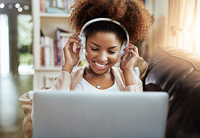 Buy stock photo Relax, laptop and black woman on sofa with headphones, smile and happy morning streaming in lounge. Rest, wellness and girl on couch in home with online music, digital app and computer in apartment.