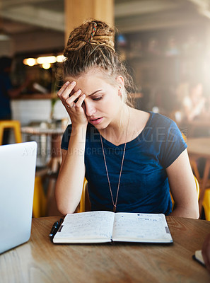 Buy stock photo Cropped shot of a young student looking stressed while studying in a cafe