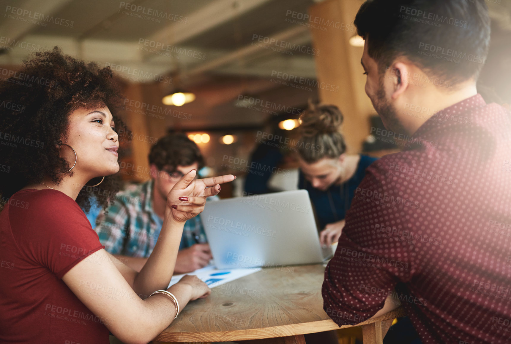 Buy stock photo Shot of students studying in a coffee shop