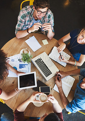 Buy stock photo High angle shot of a group of students studying in a coffee shop
