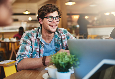 Buy stock photo Cropped shot of a young man sitting in a cafe