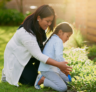 Buy stock photo Mother, child and gardening for playful, bonding or together for childhood development or learning. Woman, girl and backyard for education, nature in parenting as family in activity for growth or fun