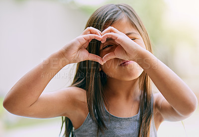 Buy stock photo Portrait of a little girl making a heart gesture with her hands