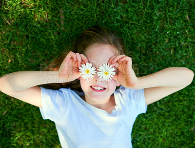 Buy stock photo Cropped shot of a little girl covering her eyes with flowers while playing outside