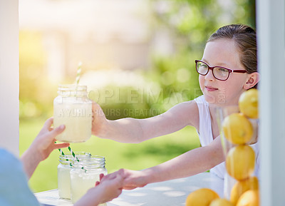 Buy stock photo Cropped shot of a little girl selling lemonade from her stand outside