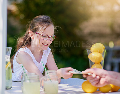 Buy stock photo Cropped shot of a little girl selling lemonade from her stand outside