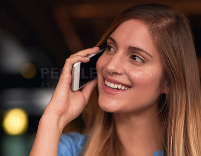 Buy stock photo Cropped shot of an attractive young woman talking on her cellphone