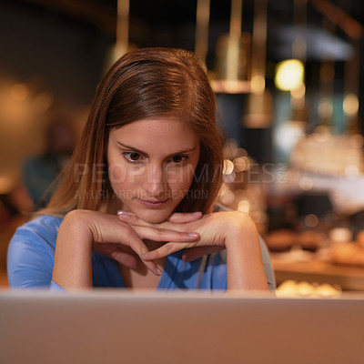 Buy stock photo Cropped sho of a young woman looking stressed while working in her local coffee shop