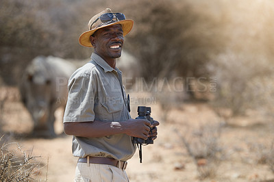 Buy stock photo Portrait, safari and wildlife with a man ranger outdoor in a game park for nature conservation. Animals, binoculars and blurred background with an african male person on patrol in the wilderness