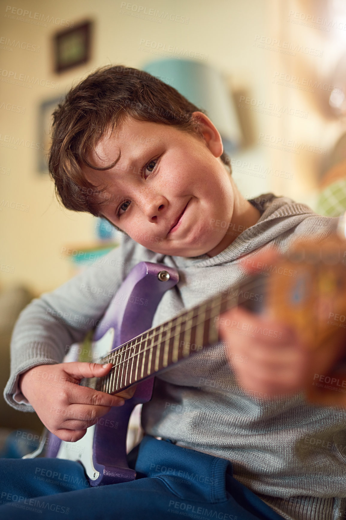 Buy stock photo Boy, electric guitar and portrait in home for music or performance, learning or development with creativity. Male child, instrument and bedroom for education in house, hopeful musician with smile