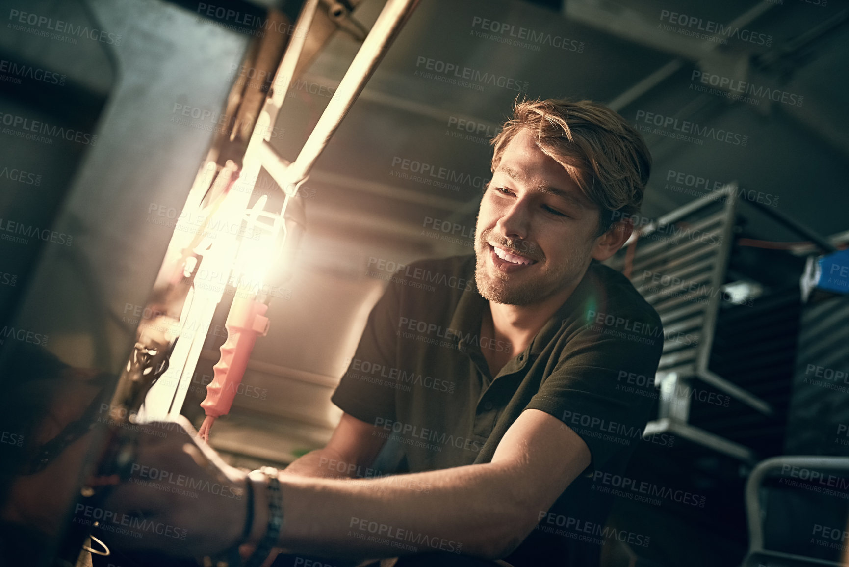 Buy stock photo Cropped shot of a handsome young man making some repairs indoors