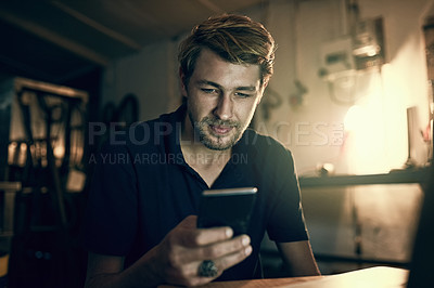 Buy stock photo Night, typing and man with mobile in office for maintenance, troubleshooting or texting instructions to client. Contact, online and handyman for communication, networking or message in workshop