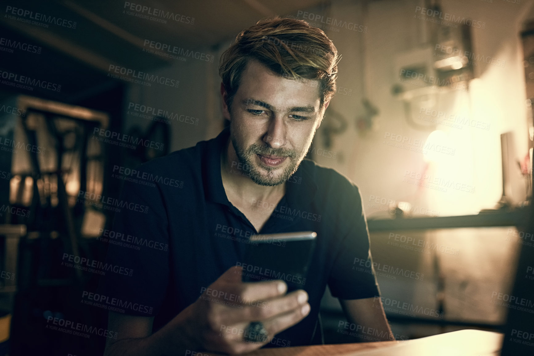 Buy stock photo Night, typing and man with mobile in office for maintenance, troubleshooting or texting instructions to client. Contact, online and handyman for communication, networking or message in workshop