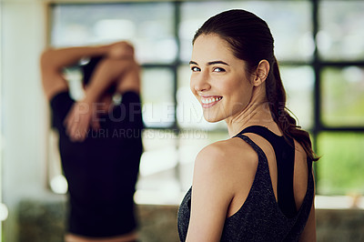 Buy stock photo Rearview portrait of an attractive young woman warming up at the gym before a workout