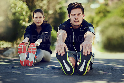 Buy stock photo Full length portrait of two young people warming up outdoors before a workout