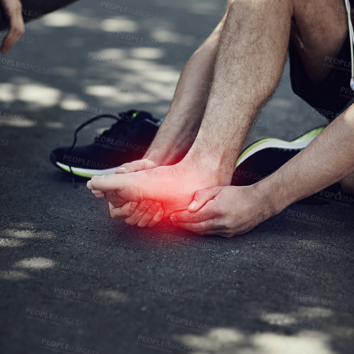 Buy stock photo Cropped shot of an unrecognizable man suffering with foot cramp during a run