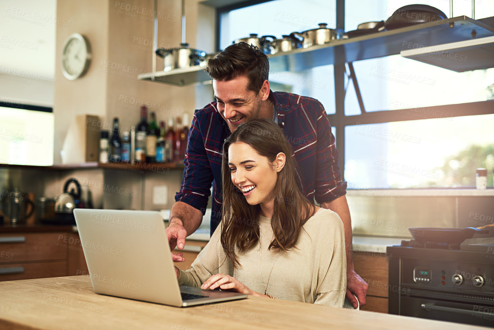 Buy stock photo Couple, laptop and reading in kitchen on internet for recipe, guide or online tutorial. Vegan blog, website and happy woman with man on computer for nutrition, healthy meal or information in home