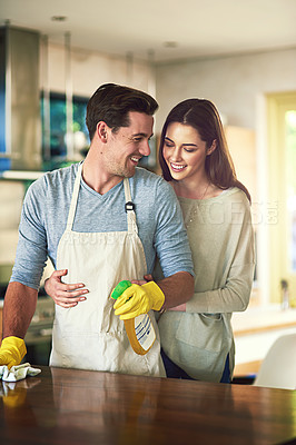 Buy stock photo Cropped shot of a young couple cleaning their kitchen together