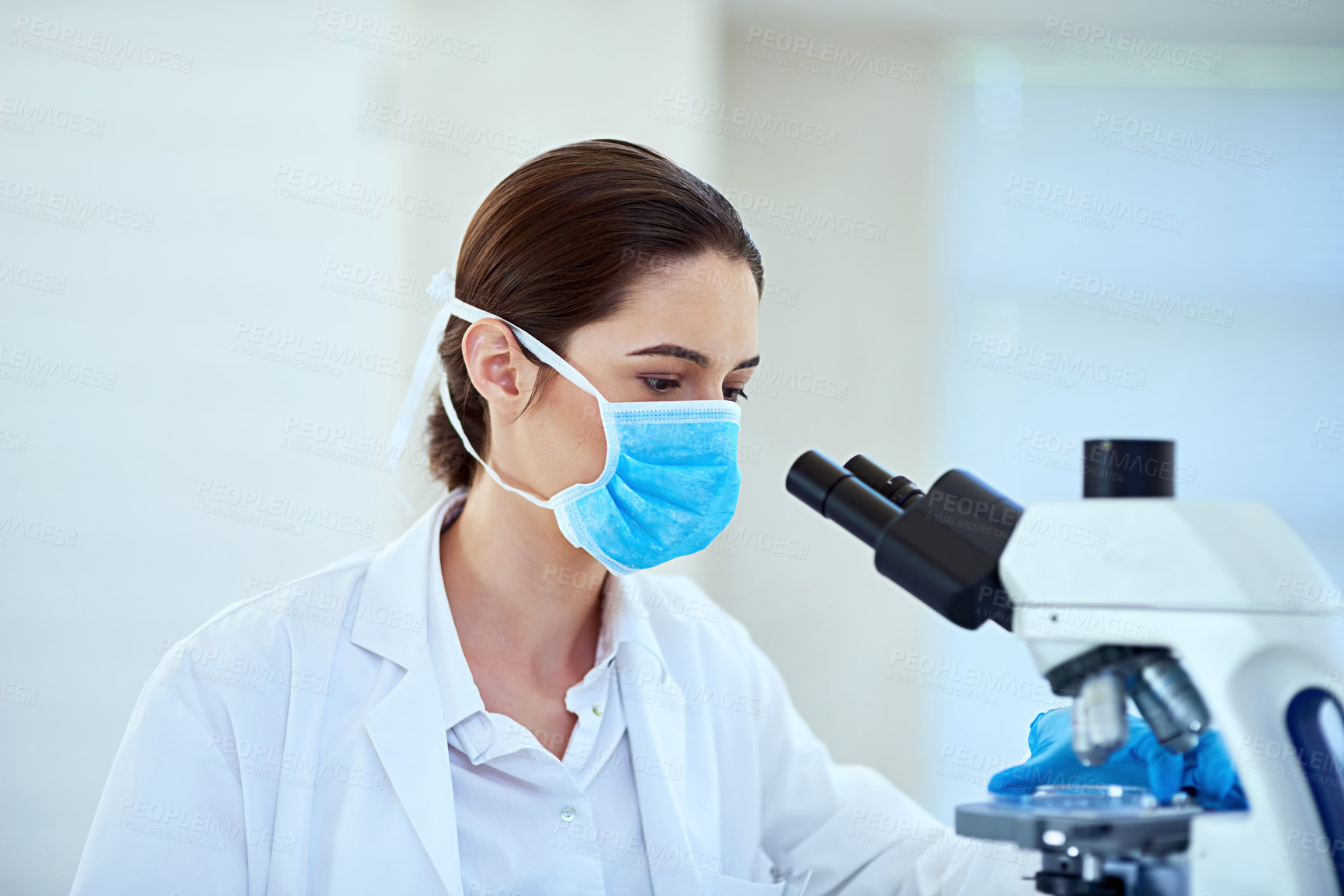Buy stock photo Science, face mask and woman with microscope in laboratory for medical discovery, research and study. Healthcare, pharmaceutical and scientist with equipment for sample, experiment and medicine