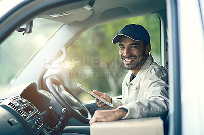 Buy stock photo Portrait of a delivery man using a digital tablet while sitting in his van